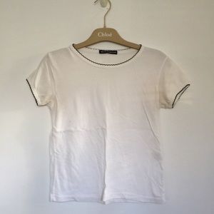 Brandy Melville white tee with black border.
